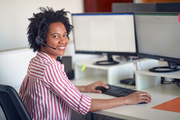 A,Young,Woman,Is,Posing,For,A,Photo,While,Working