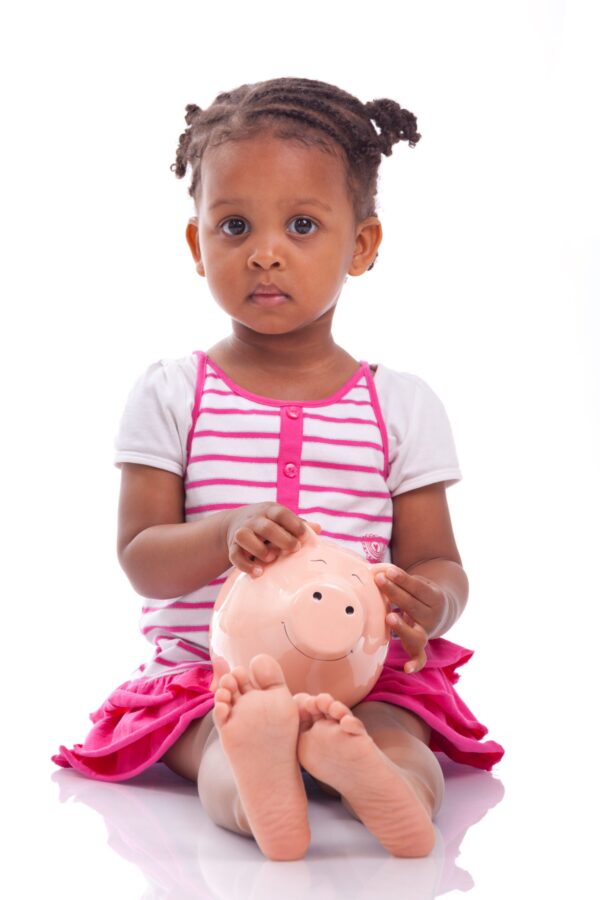 Cute,Little,Black,Girl,Holding,A,Smiling,Piggy,Bank,,Isolated