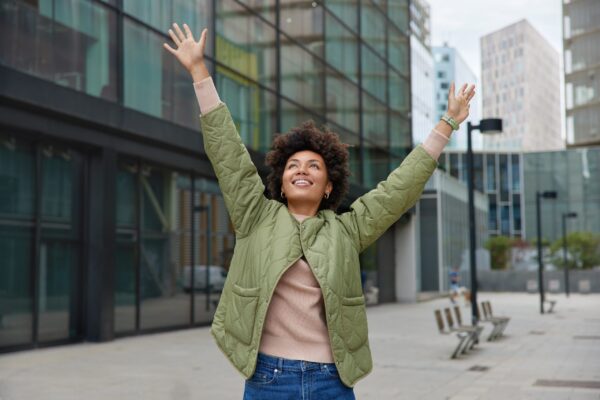 Horizontal,Shot,Of,Happy,Carefree,Woman,With,Curly,Hair,Keeps